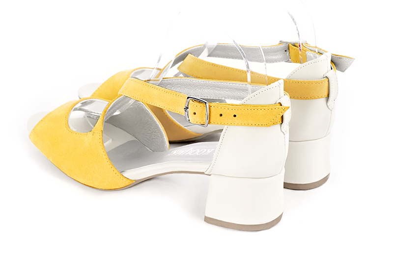 Yellow and off white women's closed back sandals, with crossed straps. Round toe. Low flare heels. Rear view - Florence KOOIJMAN